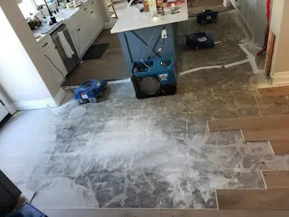 Air movers and a dehumidifier drying a wet kitchen floor in Lake Elsinore